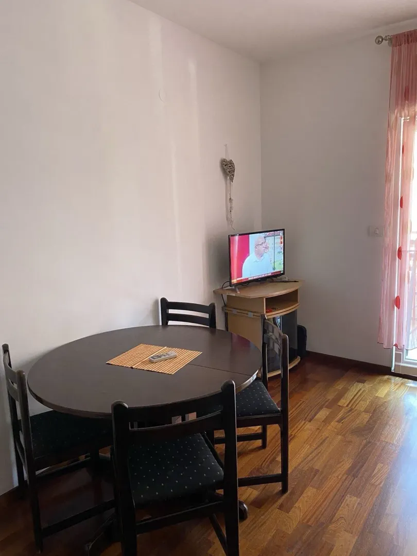 A simple dining table with chairs in a room corner.