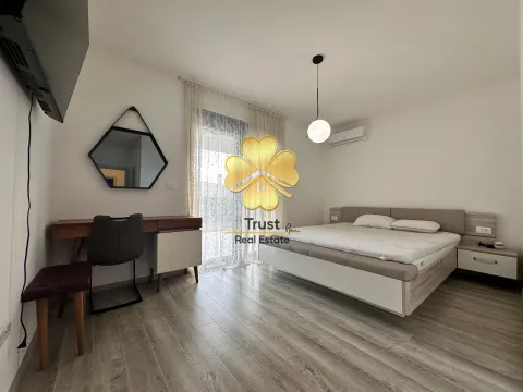 Spacious bedroom with a double bed, desk, and access to the terrace. - image 18