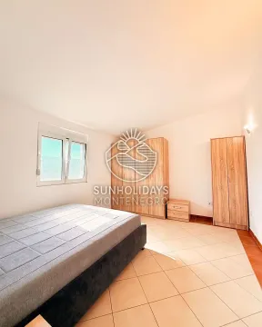 Furnished bedroom with a double bed and wooden wardrobes. - image 12