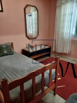 Bedroom with a bed, wall mirror, and a window. - image 3