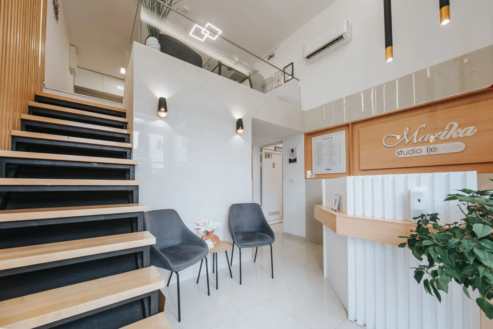 Modern interior with a staircase and a gallery.