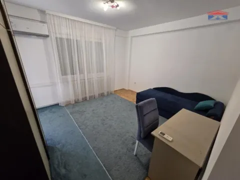 Living room with a sofa, desk, and carpet. - image 6