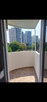 View from an open balcony towards surrounding residential buildings and greenery. - image 10