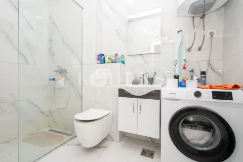 Moderno opremljeno kupatilo sa tuš kabinom i veš mašinom. - image 5