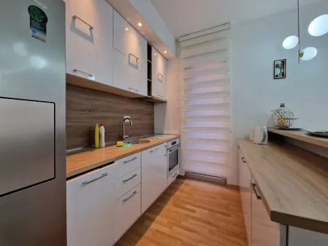 Modern kitchen with white cabinets and wooden countertops. - image 15