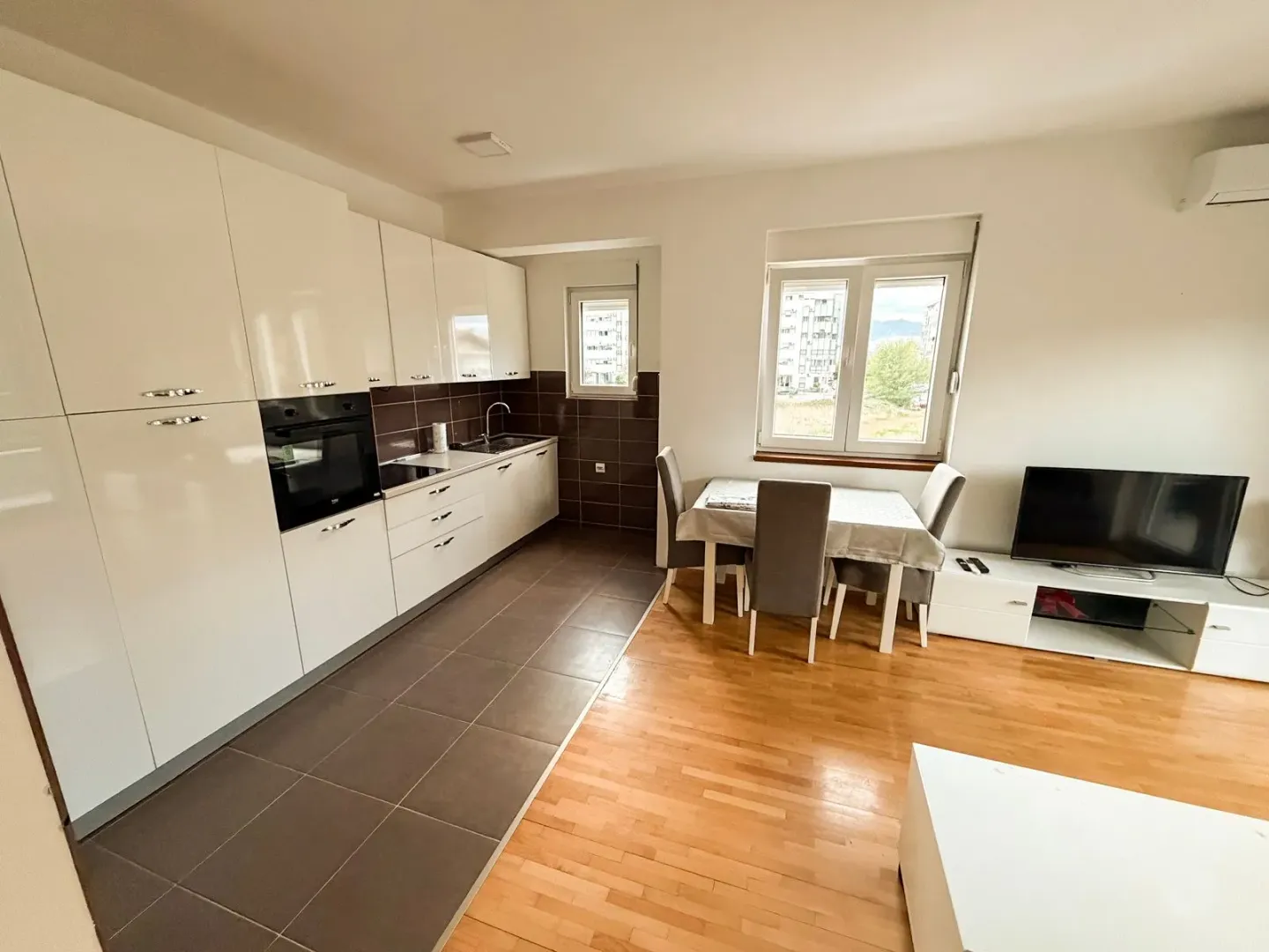 Spacious living room with a dining area and a modern fitted kitchen.