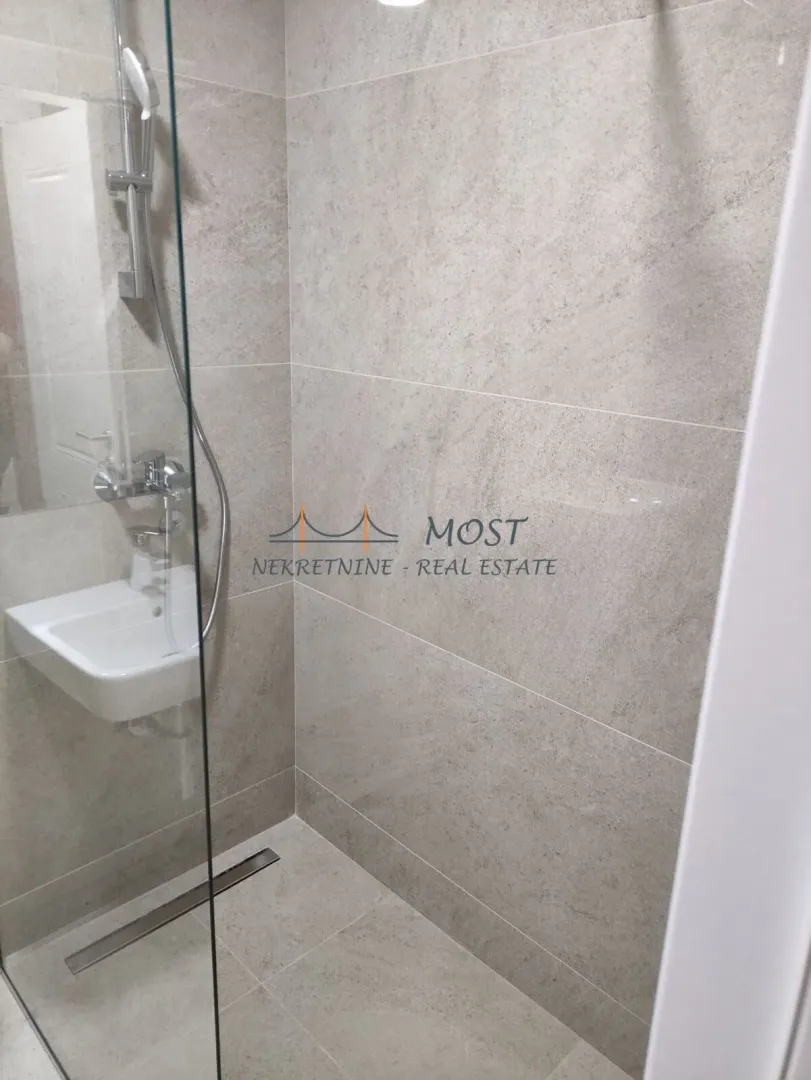 View of the shower cabin and washbasin in a modern bathroom.