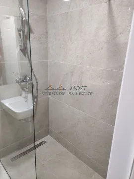View of the shower cabin and washbasin in a modern bathroom. - image 3