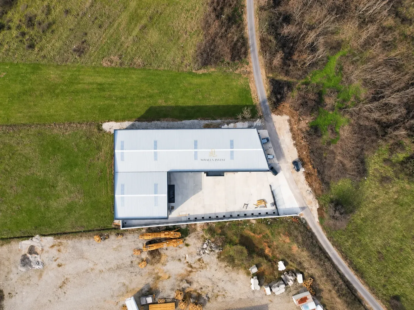 Aerial view of the warehouse with surrounding land and access road.