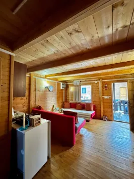 Interior of a wooden cottage with a seating set. - image 13