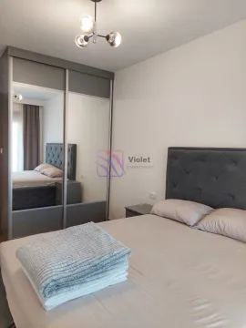 Bedroom with a double bed and a large fitted wardrobe with a mirror. - image 9