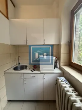 Small kitchen with white cabinets, a sink, and a countertop. - image 4