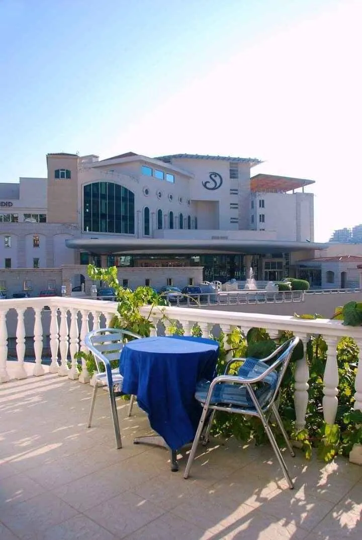 A terrace with a table and chairs overlooking the surroundings.