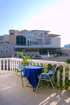 A terrace with a table and chairs overlooking the surroundings. - image 2