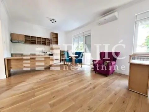 Spacious living room with a dining area and kitchen in the background. - image 7