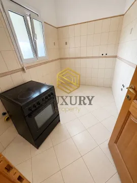 Empty kitchen with ceramic tiles and a stove. - image 4