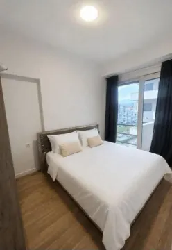 Furnished bedroom with a double bed, wooden flooring, and access to a terrace. - image 4