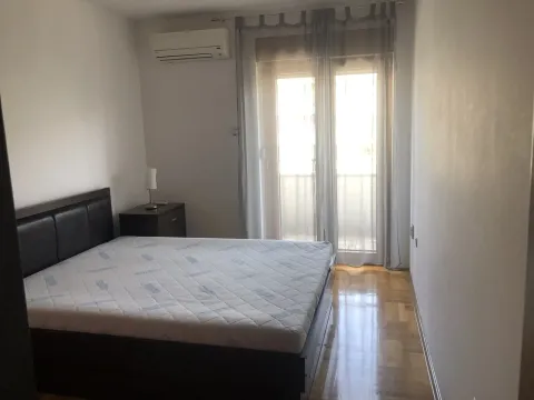 Bedroom with a double bed, nightstand, and balcony doors. - image 11