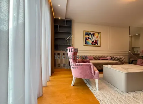 Modern and bright living room with a comfortable sofa and a pink armchair. - image 6