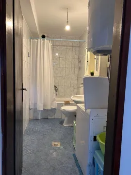 View of a small bathroom with a bathtub, sink, and toilet. - image 6
