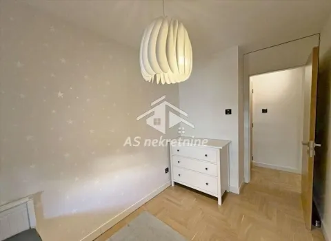 Small bedroom with a white dresser and a modern chandelier. - image 16