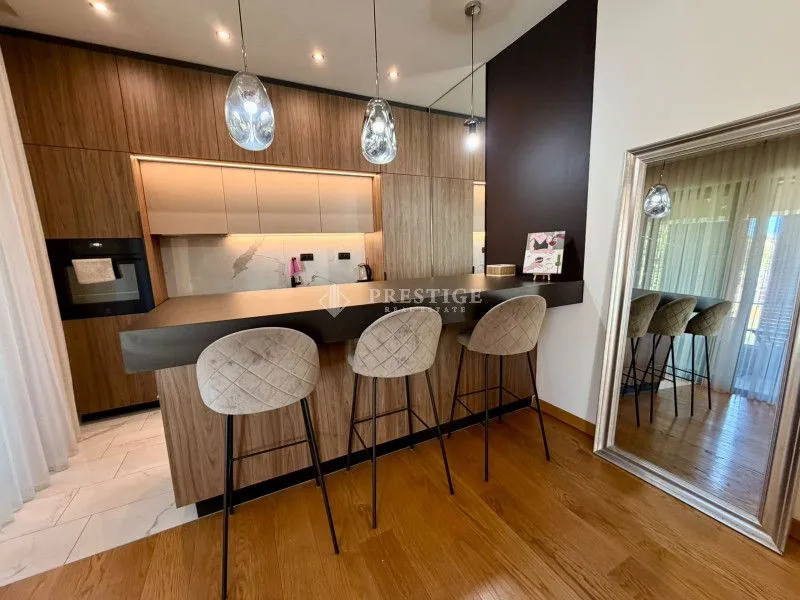 Modern kitchen with a breakfast bar and bar stools.