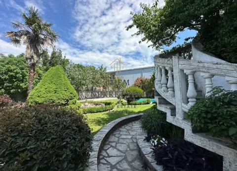 House yard with landscaped greenery, stone path and staircase. - image 3