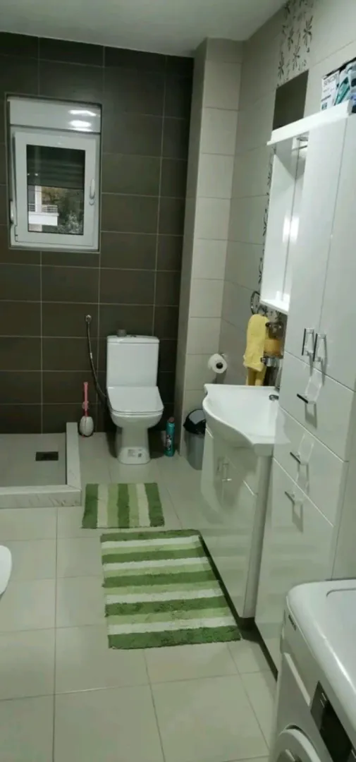 Simple bathroom with a toilet and cabinets.