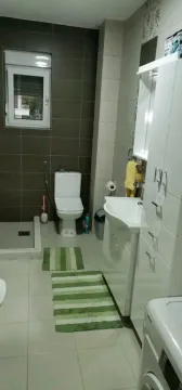 Simple bathroom with a toilet and cabinets. - image 10