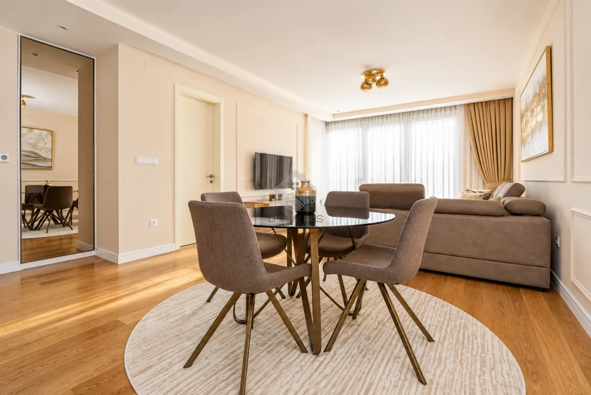 Living room with a dining table, sofa set and TV.