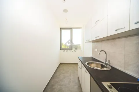 Small bright kitchen with white units and dark countertops. - image 5