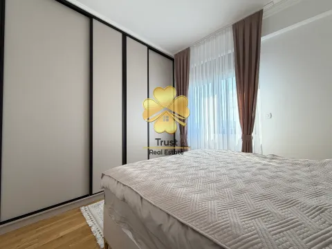 Decorated bedroom with a large double bed and a built-in wardrobe. - image 15