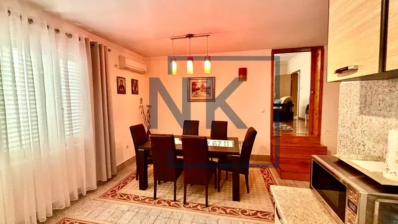 Dining area with a table and chairs connected to the kitchen.