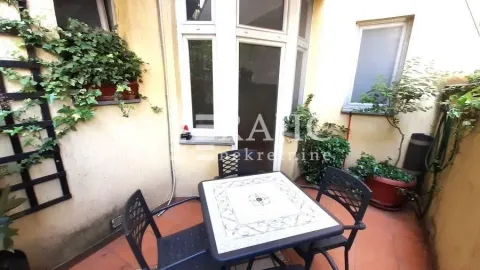 Small terrace with outdoor seating and greenery. - image 11