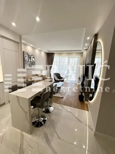 Modern living room with a breakfast bar and open-plan kitchen.