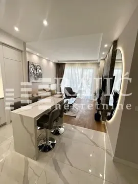 Modern living room with a breakfast bar and open-plan kitchen. - image 5