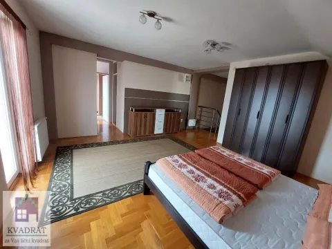 Spacious bedroom with a double bed, large wardrobe, and wooden flooring. - image 14