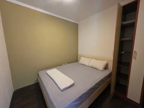 Bedroom with a double bed and an open wardrobe. - image 20