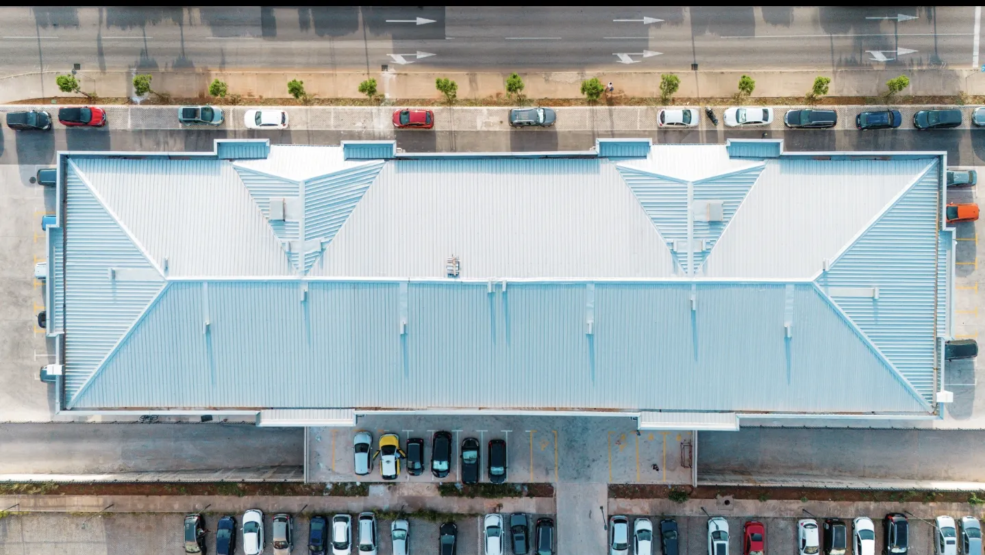 Aerial view of the building roof and surrounding parking lot.