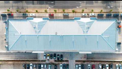 Aerial view of the building roof and surrounding parking lot. - image 15