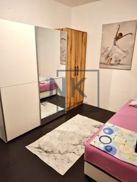 Furnished bedroom with a bed, wardrobes, and a decorative painting on the wall. - image 5