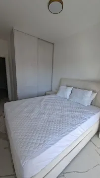 Bright bedroom with a double bed and a built-in wardrobe. - image 6