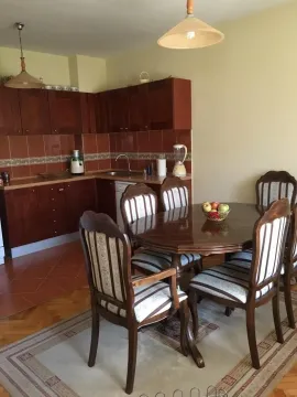 Kitchen with a dining table and wooden chairs. - image 6