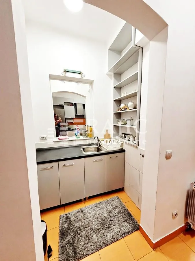 Small kitchen with built-in cabinets and a sink.
