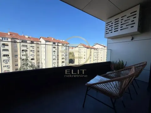 Furnished balcony with glass railing and a view of the residential area. - image 16