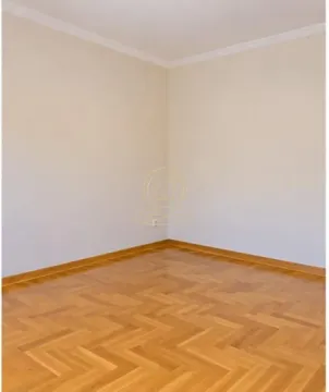 Empty room with parquet flooring and light walls. - image 9