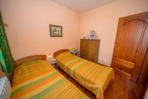 Children's bedroom with two single beds and wooden furniture. - image 34