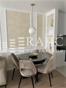 Dining area with a round table and modern upholstered chairs. - image 11