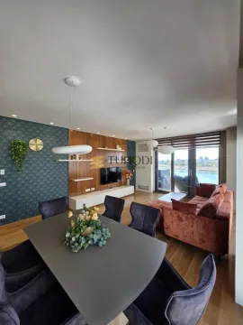 Living room with dining area and access to a terrace with a river view. - image 7