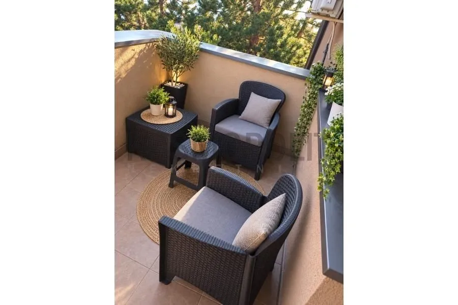 Furnished terrace with seating set and decorative plants.